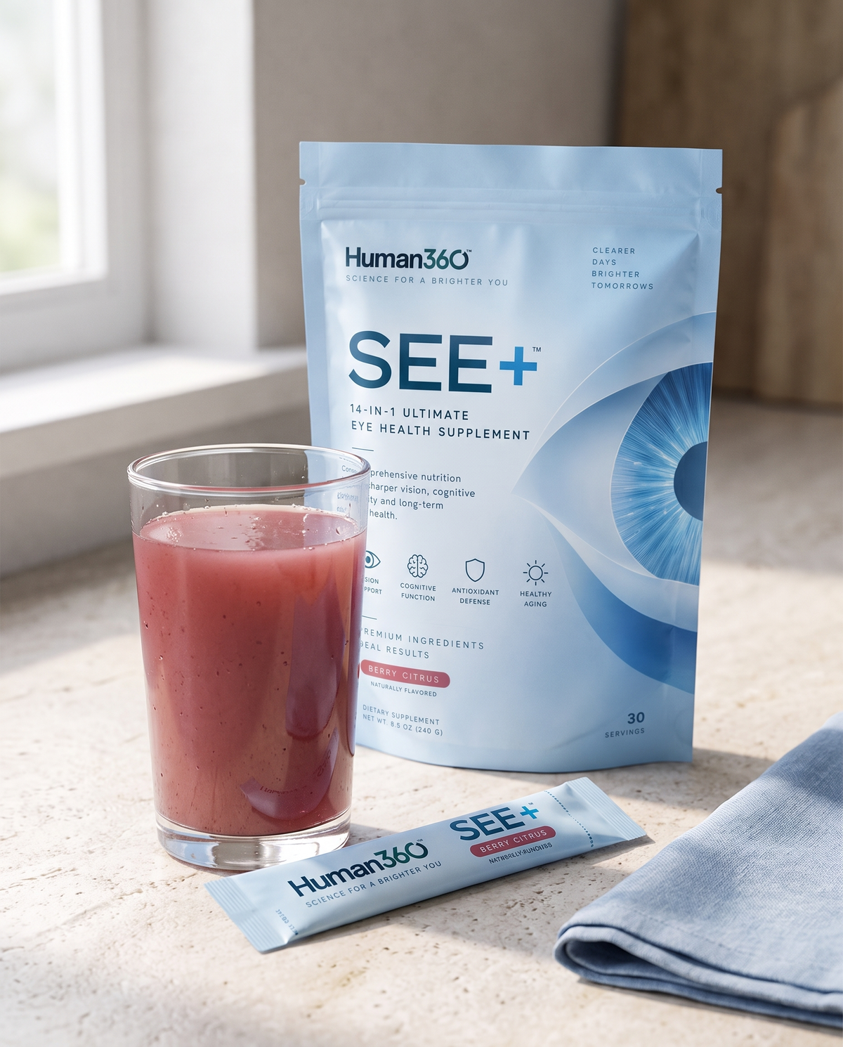 Illustrative SEE+ powder sachet and mixed drink on a kitchen counter.
